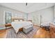 Spacious primary bedroom with hardwood floors, a ceiling fan, and a cozy sitting area at 57 Moury Se Ave, Atlanta, GA 30315