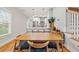 Bright dining room with hardwood floors adjacent to a modern, open kitchen area at 57 Moury Se Ave, Atlanta, GA 30315