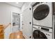 Convenient laundry area with stacked washer and dryer; hardwood floors and natural light at 57 Moury Se Ave, Atlanta, GA 30315