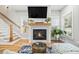 Bright living room featuring a cozy fireplace, hardwood floors, and natural light from multiple windows at 57 Moury Se Ave, Atlanta, GA 30315