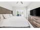 Cozy main bedroom with television, dresser, and bright, sunlit windows at 57 Moury Se Ave, Atlanta, GA 30315