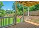 Inviting porch with wooden decking and white railings, overlooking a green backyard with a charming fence at 57 Moury Se Ave, Atlanta, GA 30315