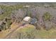 Aerial view of property featuring multiple outbuildings, barn and a large area of land with mature trees at 346 Mays Rd, Stockbridge, GA 30281