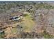 The aerial view showcases the pool, house, and additional outbuildings amongst a lush wooded surround at 346 Mays Rd, Stockbridge, GA 30281