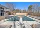 Backyard pool with safety cover and diving board, is surrounded by an expansive wooden deck at 346 Mays Rd, Stockbridge, GA 30281