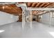 Unfinished basement with visible ductwork, support beams, stairs, and a brick fireplace at 346 Mays Rd, Stockbridge, GA 30281