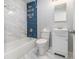 Bathroom with shower over tub, blue tiling accent and marble style flooring at 346 Mays Rd, Stockbridge, GA 30281