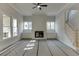 Spacious living room featuring a fireplace, built-in shelves, large windows, and stairs leading to the second floor at 4348 Hamilton Mill Rd, Buford, GA 30518