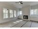 Bright living room with custom built-ins, fireplace, and expansive windows offering abundant natural light at 4348 Hamilton Mill Rd, Buford, GA 30518