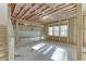 Unfinished basement with exposed framing, insulation, and natural light from the windows at 4356 Hamilton Mill Rd, Buford, GA 30518