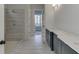 Bright bathroom featuring a tiled shower with dual showerheads and a double vanity with white countertop at 4356 Hamilton Mill Rd, Buford, GA 30518