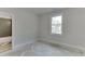 Unfinished bedroom featuring a window and a doorway view to an adjacent bathroom at 4356 Hamilton Mill Rd, Buford, GA 30518