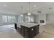 Open-concept kitchen includes an island with sink and views of the living area at 4356 Hamilton Mill Rd, Buford, GA 30518