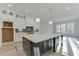 Bright kitchen features an island, white cabinets, and modern pendant lighting at 4356 Hamilton Mill Rd, Buford, GA 30518