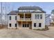 Rear view of a two-story home with brick exterior, patio, and manicured lawn at 4356 Hamilton Mill Rd, Buford, GA 30518