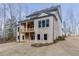 Back exterior of a two-story home with a brick facade, covered porch, and large windows at 4356 Hamilton Mill Rd, Buford, GA 30518