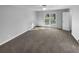 Spacious bedroom featuring neutral walls, carpet, ceiling fan and a large window at 1720 Winners Cir, Lawrenceville, GA 30043