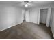 Spacious bedroom with a ceiling fan, neutral walls, and two closets at 1720 Winners Cir, Lawrenceville, GA 30043