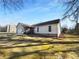 View of the side of the home highlighting the siding, and a partially wooded lot at 1720 Winners Cir, Lawrenceville, GA 30043