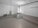 Spacious garage with sealed concrete floor, attached garage door opener and access to home with small stair case at 1720 Winners Cir, Lawrenceville, GA 30043