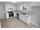 Efficient kitchen featuring white cabinets, stainless steel appliances, and a neutral color scheme at 1720 Winners Cir, Lawrenceville, GA 30043