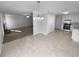 Combined kitchen and dining area with tile floors, modern pendant lighting, and view to the living room area at 1720 Winners Cir, Lawrenceville, GA 30043