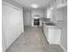 Functional kitchen featuring white cabinets, modern appliances, and a tile floor for easy cleaning and meal preparation at 1720 Winners Cir, Lawrenceville, GA 30043