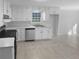 Well-lit kitchen with white cabinets, stainless steel appliances, and a clean design at 1720 Winners Cir, Lawrenceville, GA 30043