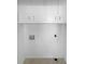 Dedicated laundry area with white cabinets, neutral tile floor, and wall hook-ups for your washer and dryer at 1720 Winners Cir, Lawrenceville, GA 30043