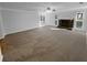 Spacious living room featuring neutral walls, carpet, fireplace and lots of natural light at 1720 Winners Cir, Lawrenceville, GA 30043