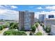 An exterior shot of the building shows a tall condo in a developed area at 215 Piedmont Ave # Apt 402, Atlanta, GA 30308