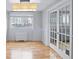 Bright living room features hardwood floors, a window with city views, and stylish French doors at 215 Piedmont Ave # Apt 402, Atlanta, GA 30308