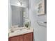 Well-lit bathroom with a cherry wood vanity, offering a blend of traditional charm and modern functionality at 2565 Rocky Ct, South Fulton, GA 30349