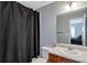 Bathroom featuring a shower with a dark curtain, white cabinets, and a large mirror at 2565 Rocky Ct, South Fulton, GA 30349