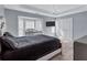 Stylish bedroom with tray ceilings, a modern chandelier, and large windows, creating a luxurious space at 2565 Rocky Ct, South Fulton, GA 30349