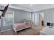 Cozy bedroom with tray ceilings, enhanced by natural light and a comfortable layout, ideal for relaxation at 2565 Rocky Ct, South Fulton, GA 30349
