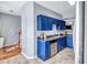 Well-designed kitchen boasts blue cabinets and stainless steel appliances, complemented by a neutral tile floor at 2565 Rocky Ct, South Fulton, GA 30349