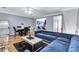 Open-concept living room with hardwood floors, dining set, and blue velvet sofa at 2565 Rocky Ct, South Fulton, GA 30349