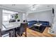 Well-lit living space shows open floorplan into kitchen with dining area and velvet sofa at 2565 Rocky Ct, South Fulton, GA 30349
