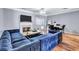 Living room with fireplace, dining area, and blue velvet sectional at 2565 Rocky Ct, South Fulton, GA 30349