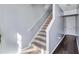 Carpeted staircase with white railing connecting floors, adjacent to hardwood flooring at 2565 Rocky Ct, South Fulton, GA 30349