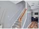 Elegant staircase with wood railing and carpeted steps, providing a safe and stylish transition between floors at 2565 Rocky Ct, South Fulton, GA 30349