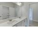 Bathroom featuring double vanity with stone countertops and ample mirror space at 2870 S Waterworks Rd, Buford, GA 30518