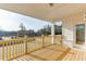 View of the outdoor porch with wooden railings and a doorway leading inside at 2870 S Waterworks Rd, Buford, GA 30518