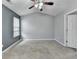 Bedroom featuring carpeted floors, a ceiling fan and a window that brings in natural light at 3154 Panthers Trce, Decatur, GA 30034