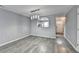 Open dining room with gray LVP flooring connects the kitchen and the front entry at 3154 Panthers Trce, Decatur, GA 30034