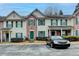 Attractive townhome exterior features a brick facade, neutral siding, and green shutters, creating a welcoming curb appeal at 3154 Panthers Trce, Decatur, GA 30034