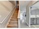 Hallway with stairs and railing, leading to the kitchen and living room at 3154 Panthers Trce, Decatur, GA 30034