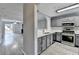 Modern kitchen featuring stainless steel appliances, gray cabinets, and an open layout to the living area at 3154 Panthers Trce, Decatur, GA 30034