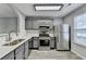 Stylish kitchen boasting gray cabinetry, stainless steel appliances, and abundant counter space for cooking and entertaining at 3154 Panthers Trce, Decatur, GA 30034